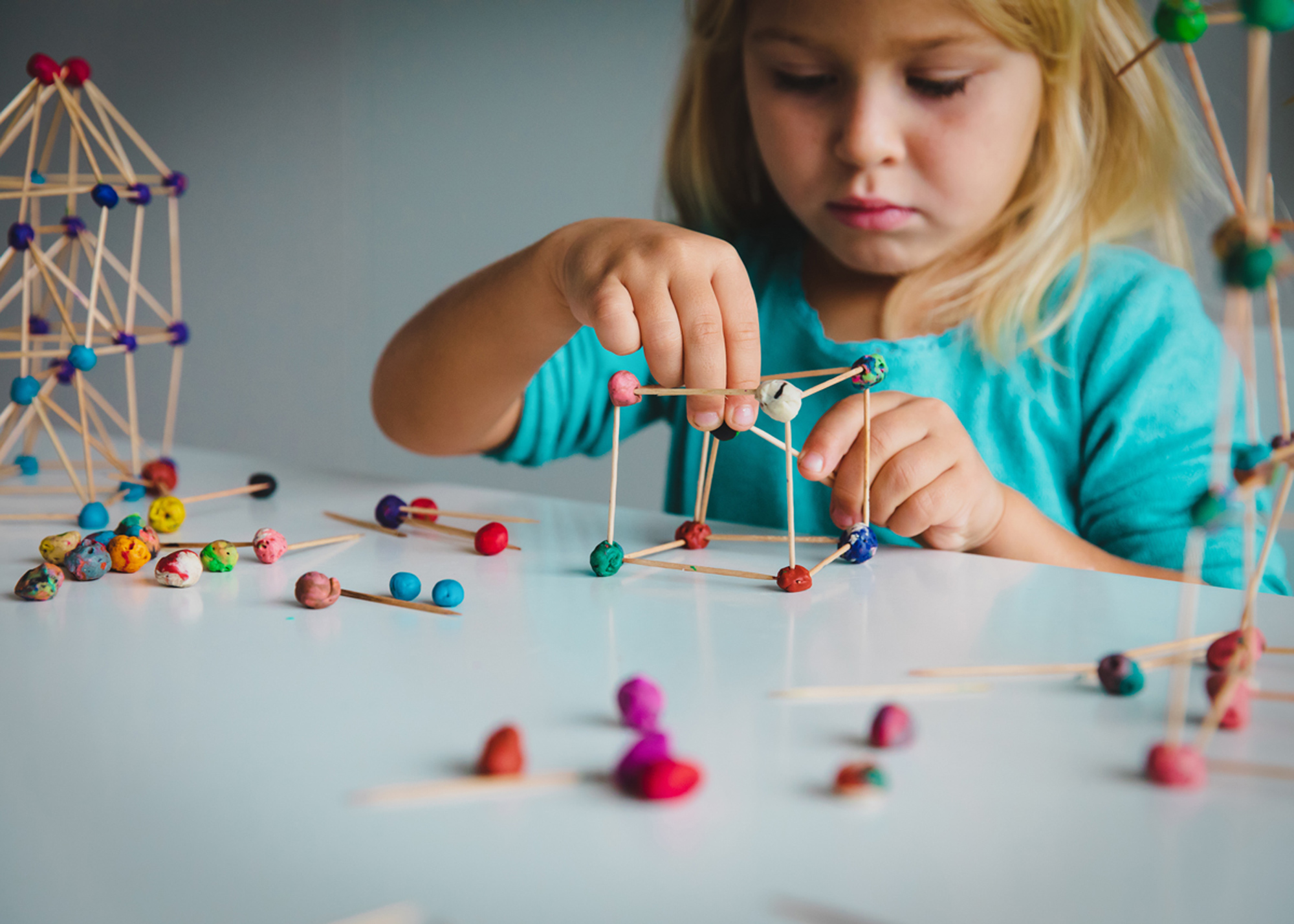 young girl child making geometric shapes, engineering and STEM